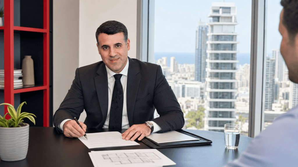 Asaf Arazi-Biton reviewing an apartment purchase agreement in a law office