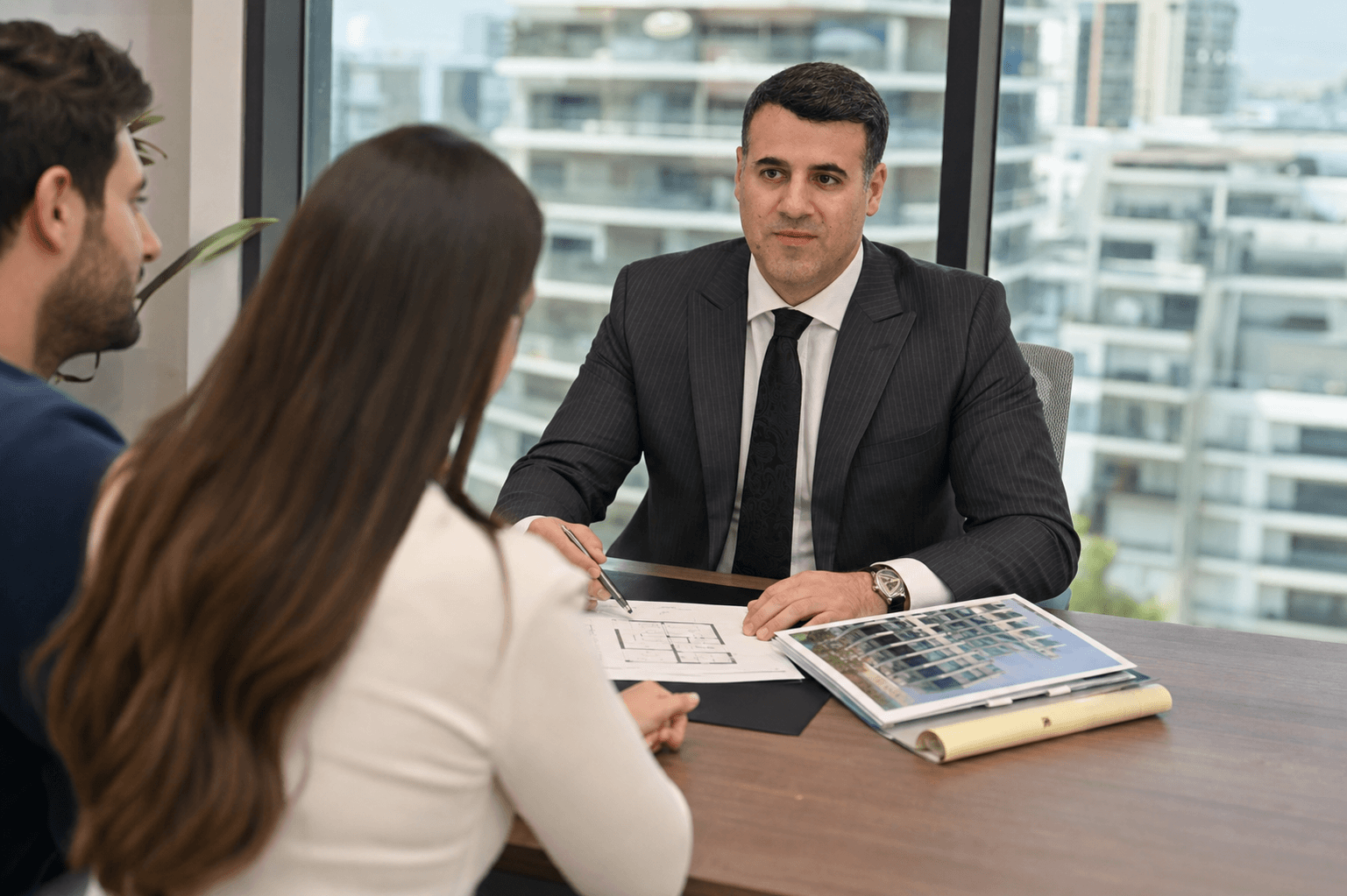 Attorney Asaf Arazi-Biton advising a young couple on a prenuptial agreement for an apartment