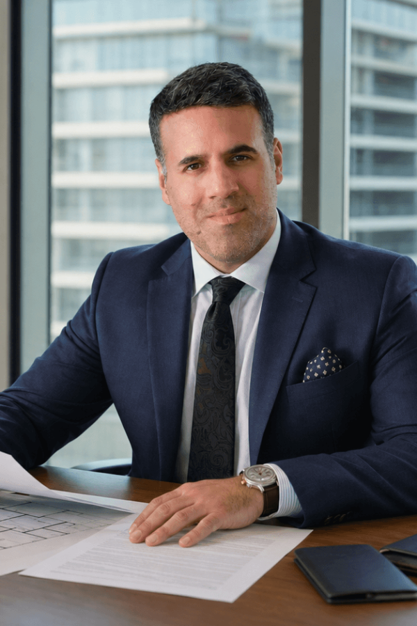 Asaf Arazi-Biton reviewing apartment purchase documents for new immigrants in Israel