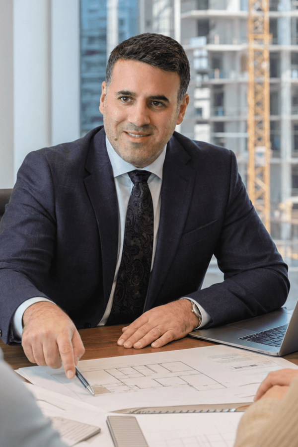 Asaf Arazi-Biton advising clients before signing a Mechir LaMishtaken apartment purchase agreement in Israel