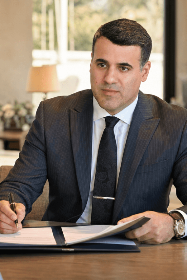 Attorney Asaf Arazi-Biton reviewing an assisted living agreement with an older couple