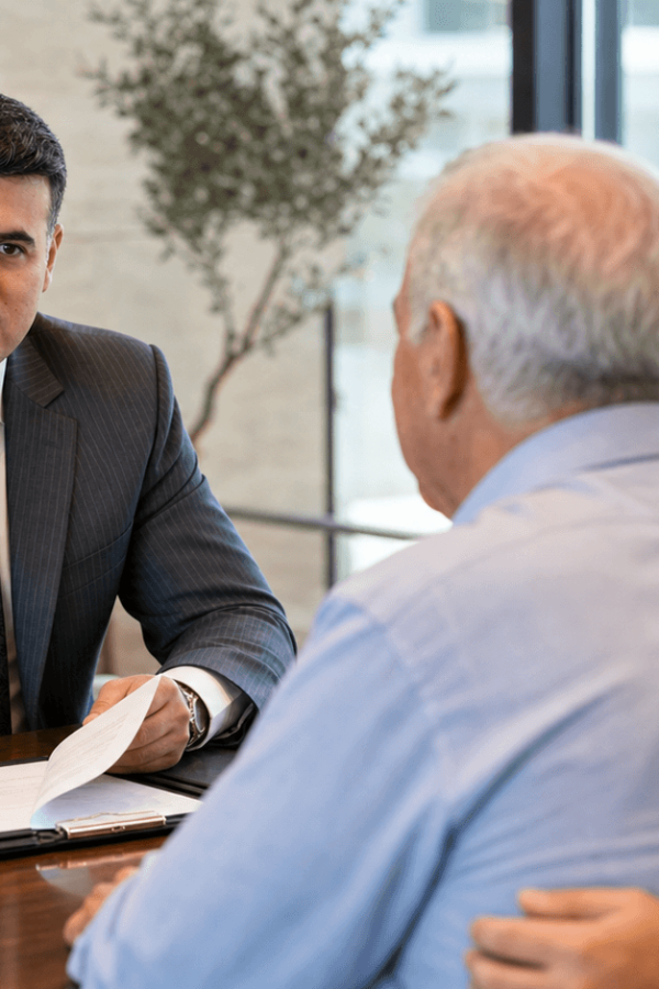 Asaf Arazi-Bitton reviewing an assisted living agreement before signing with an older couple and a family member
