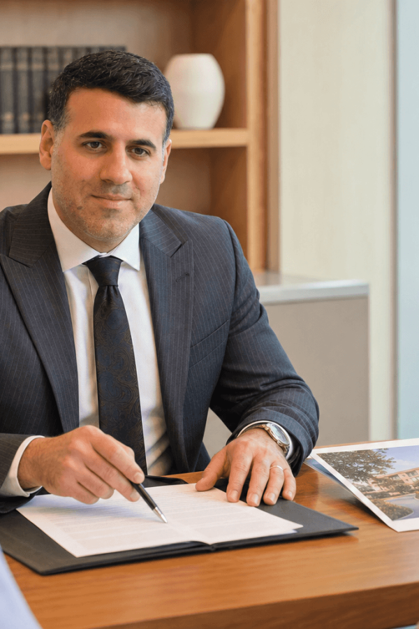Attorney Asaf Arazi-Biton reviewing an assisted living entry agreement with an older couple