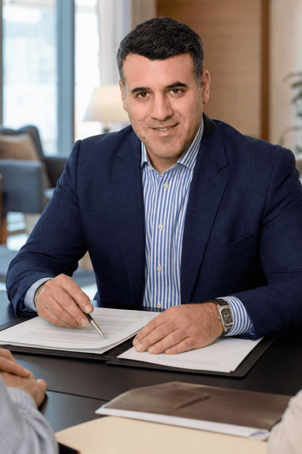 Attorney Asaf Arazi-Biton reviewing an assisted living agreement with an older couple