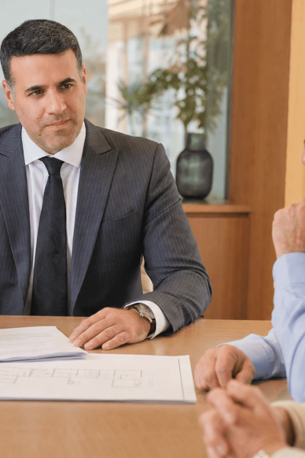 Asaf Arazi-Biton advising an older couple on estate planning, enduring power of attorney and real estate assets