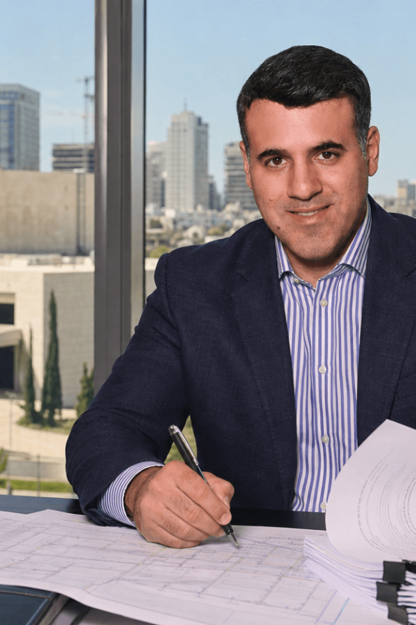 Asaf Arazi-Biton reviewing improvement levy legal documents after a Supreme Court ruling