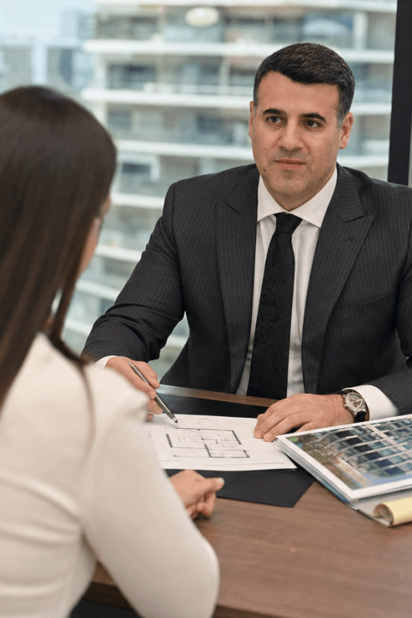 Attorney Asaf Arazi-Biton advising a young couple on a prenuptial agreement for an apartment